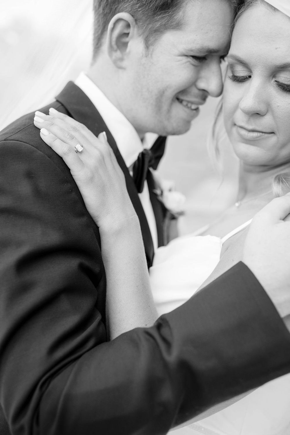 A romantic black and white photo series showing tender moments between a bride and groom on their wedding day.