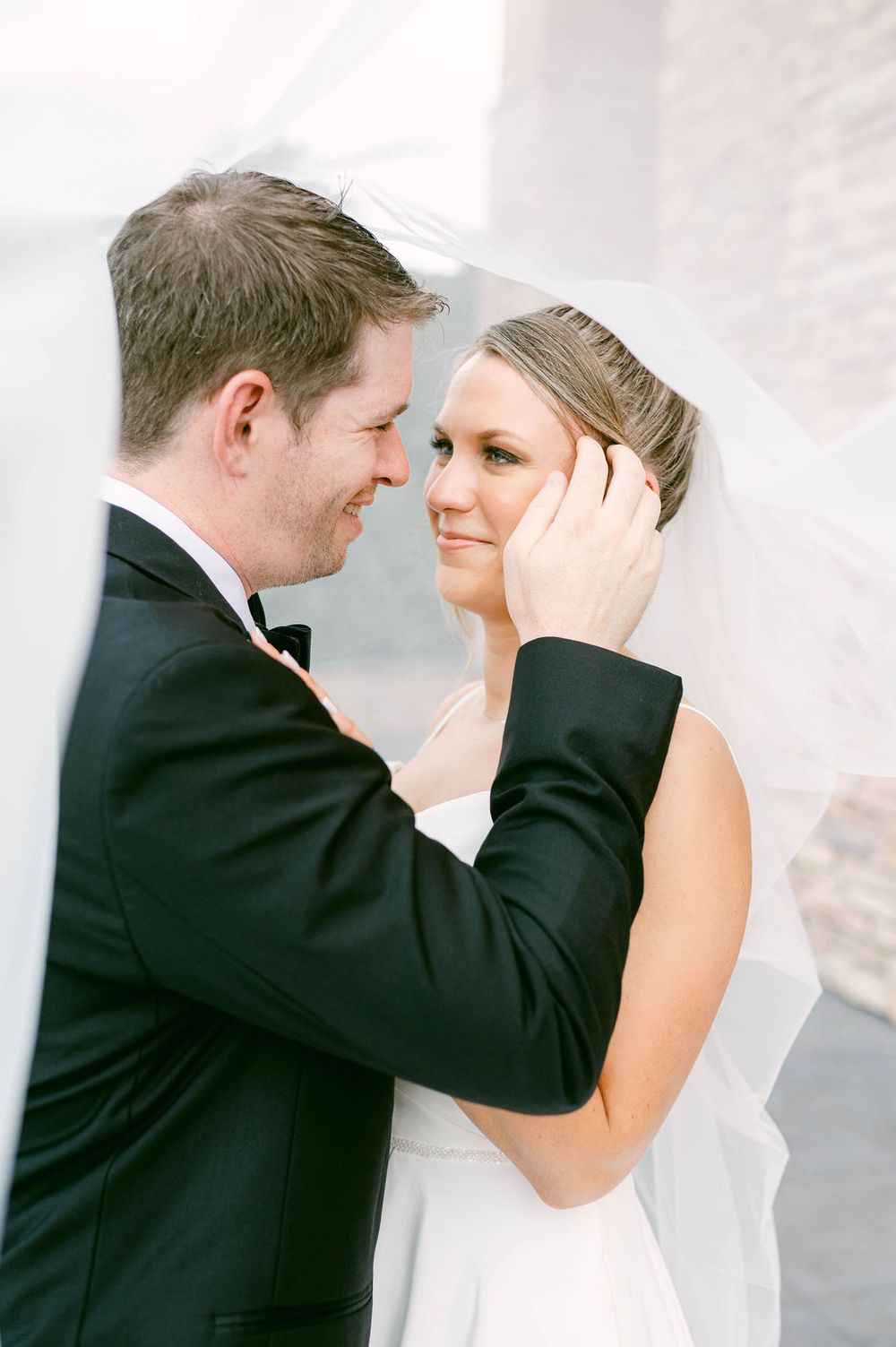 A tender moment between newlyweds as they share an intimate embrace during their wedding photoshoot.