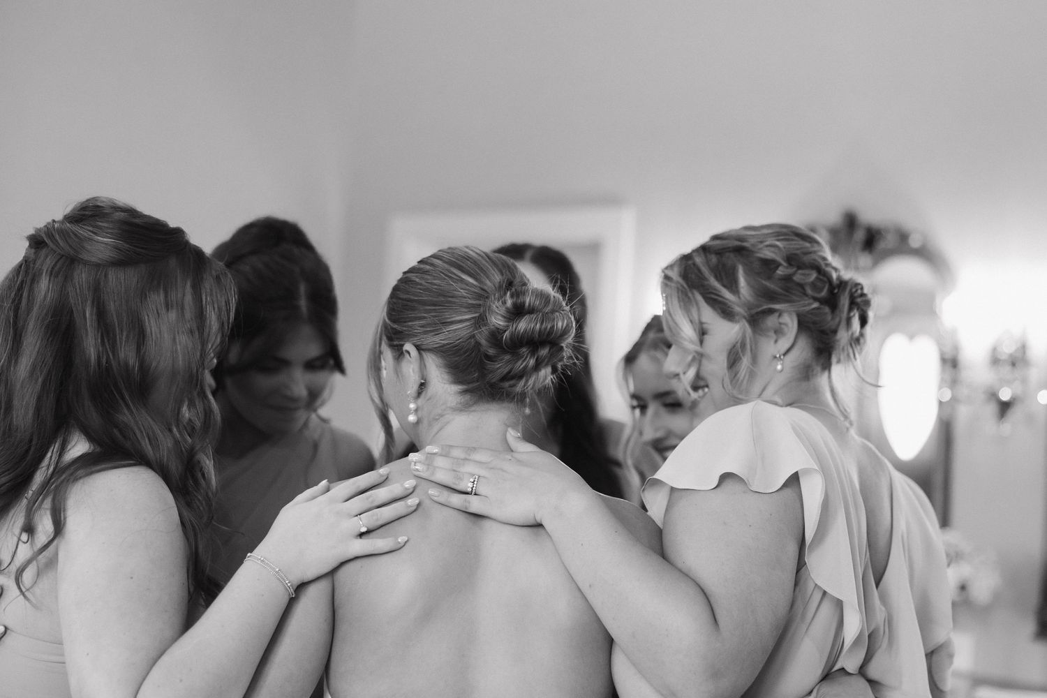 A series of black and white photographs showing people embracing in emotional moments.
