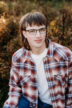 A series of outdoor portrait photos showing someone wearing a plaid flannel shirt and white t-shirt against an autumn background.