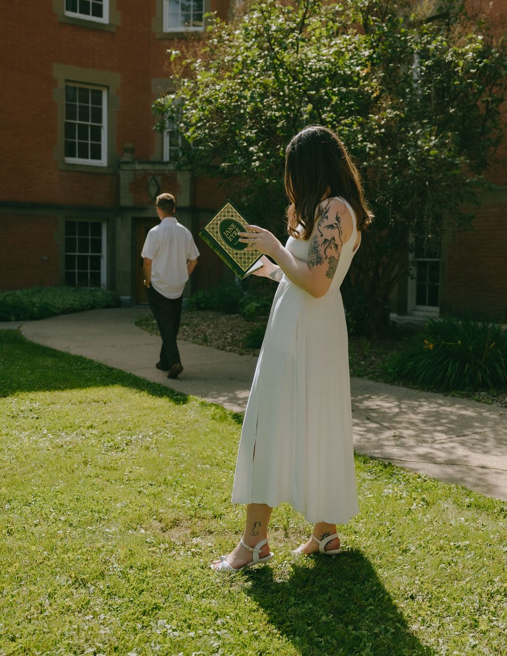 A sequence of photos showing people in white dresses walking through a sunny garden path beside a brick building.