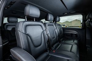 Black leather rear seats with headrests in a modern luxury vehicle interior showing comfortable passenger accommodation.