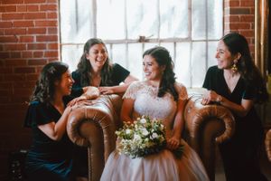 Bridesmaids laugh while getting ready at The Cookery in Durham NC