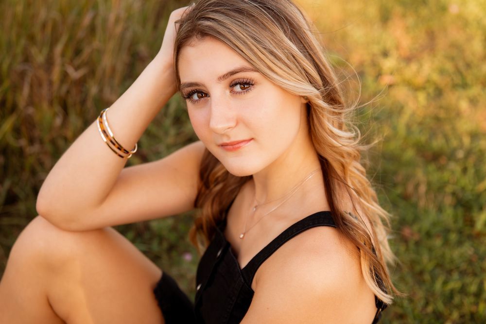 Outdoor portrait session in golden field during sunset lighting.