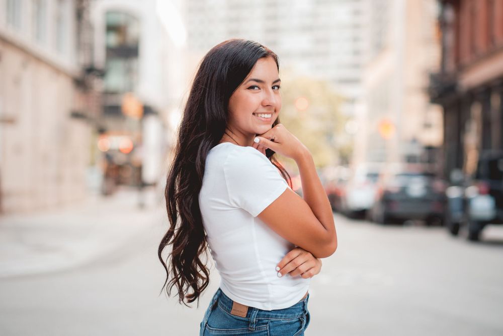 Casual lifestyle portraits in urban setting with brick buildings in background.