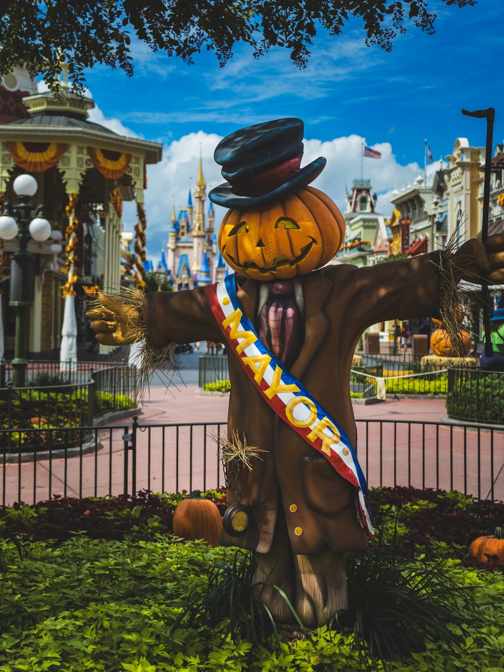 Halloween decorations featuring pumpkins and fall foliage line Magic Kingdom's Main Street.