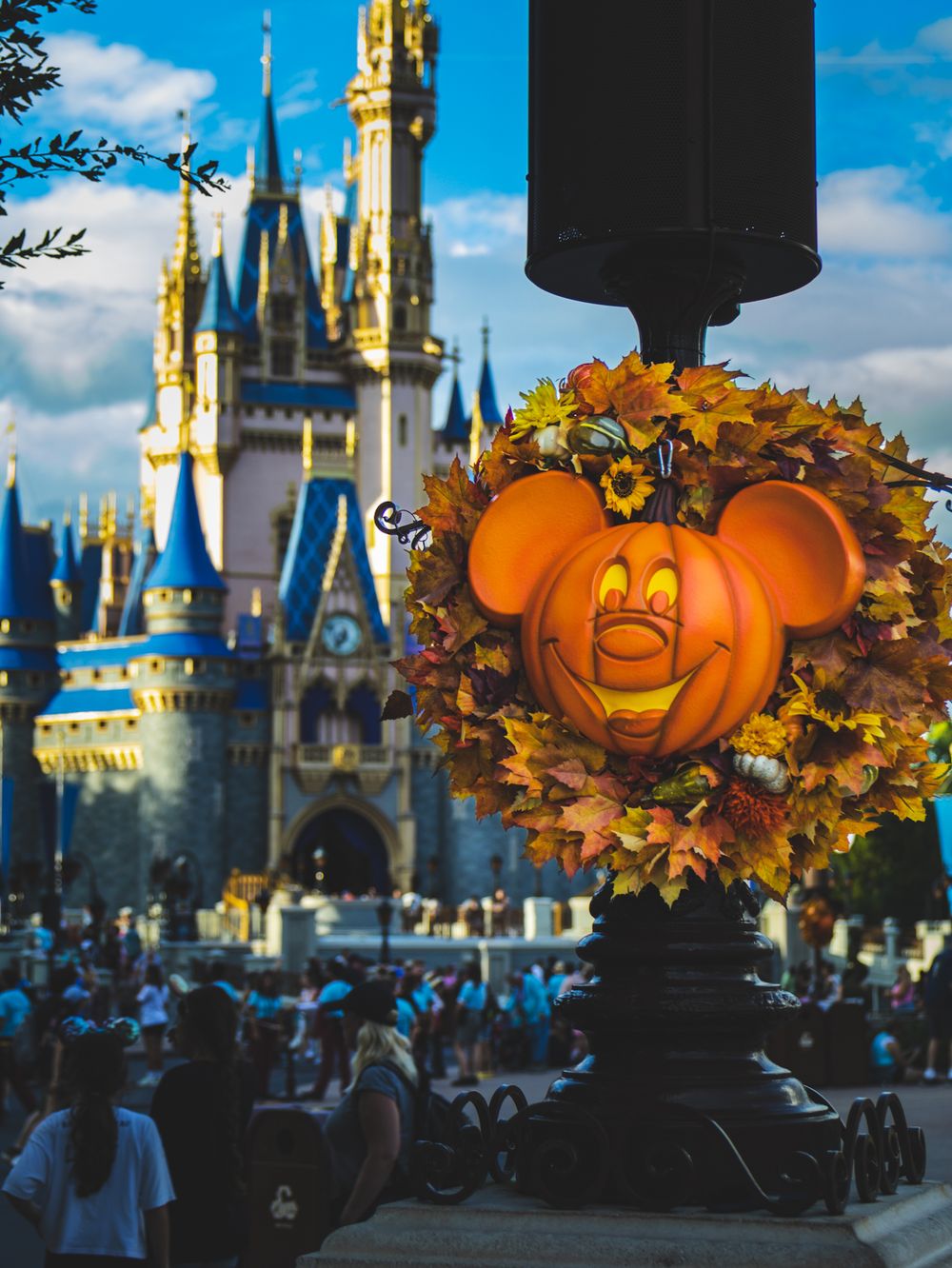 Halloween pumpkin decorations silhouetted against Cinderella Castle at Magic Kingdom.