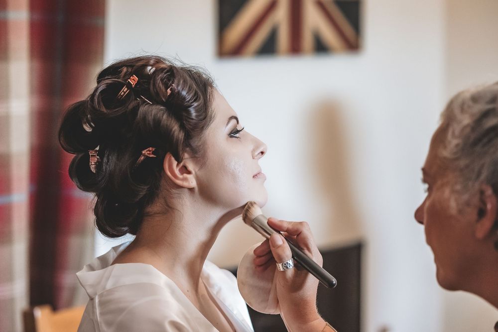 A natural photo of a bride during makeup on her wedding morning.