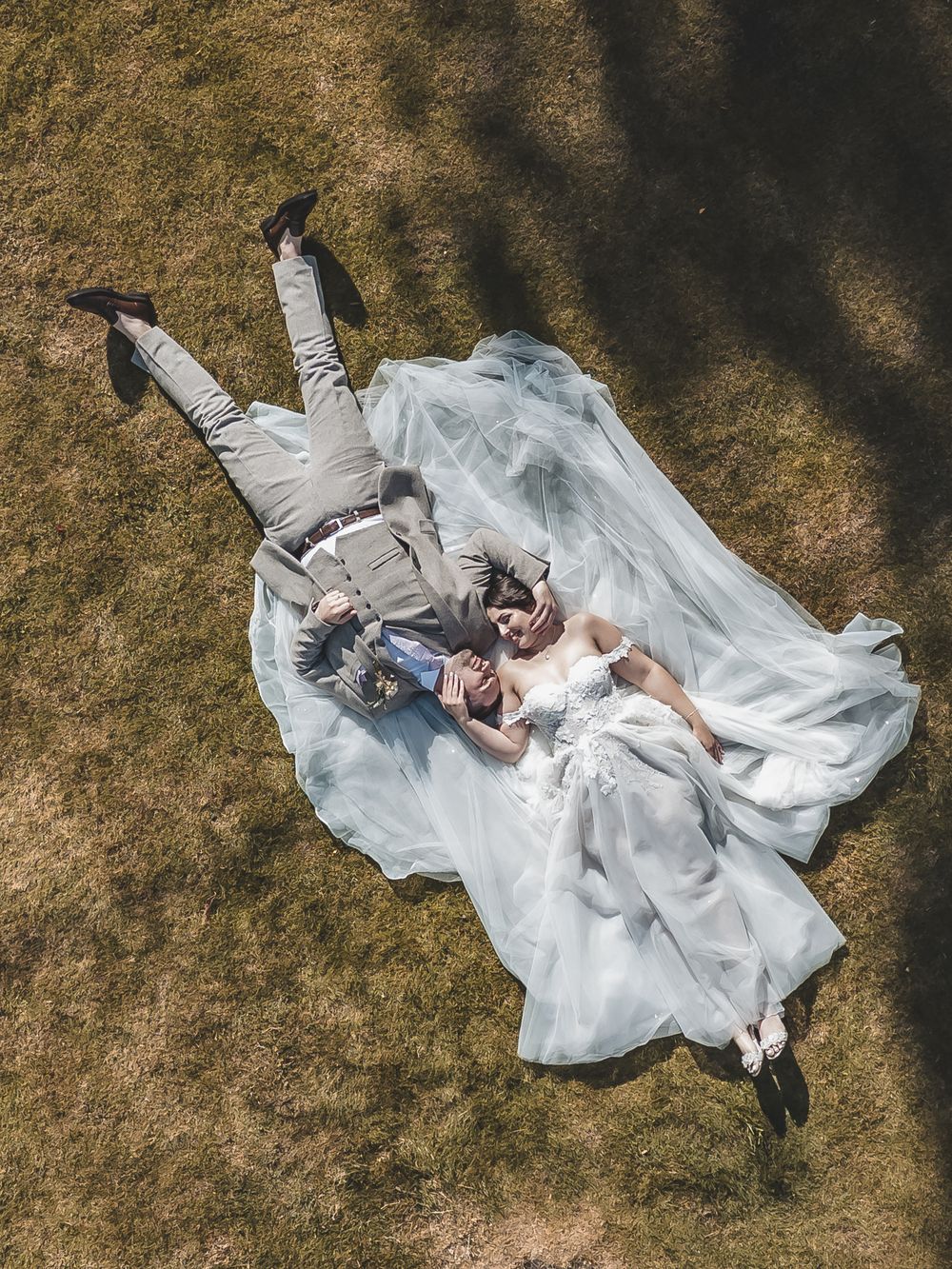 A relaxed aerial view of bride and groom sharing a moment on their wedding day.