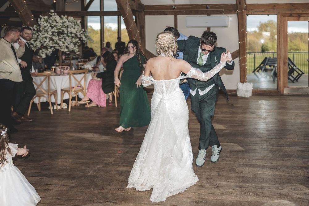 Documentary wedding photography capturing a natural moment of bride and groom on the dance floor.