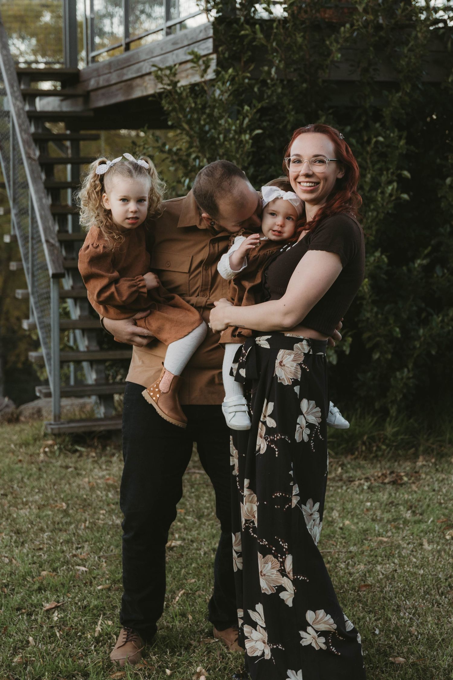 Candid moments of joy and laughter during an outdoor family photoshoot.
