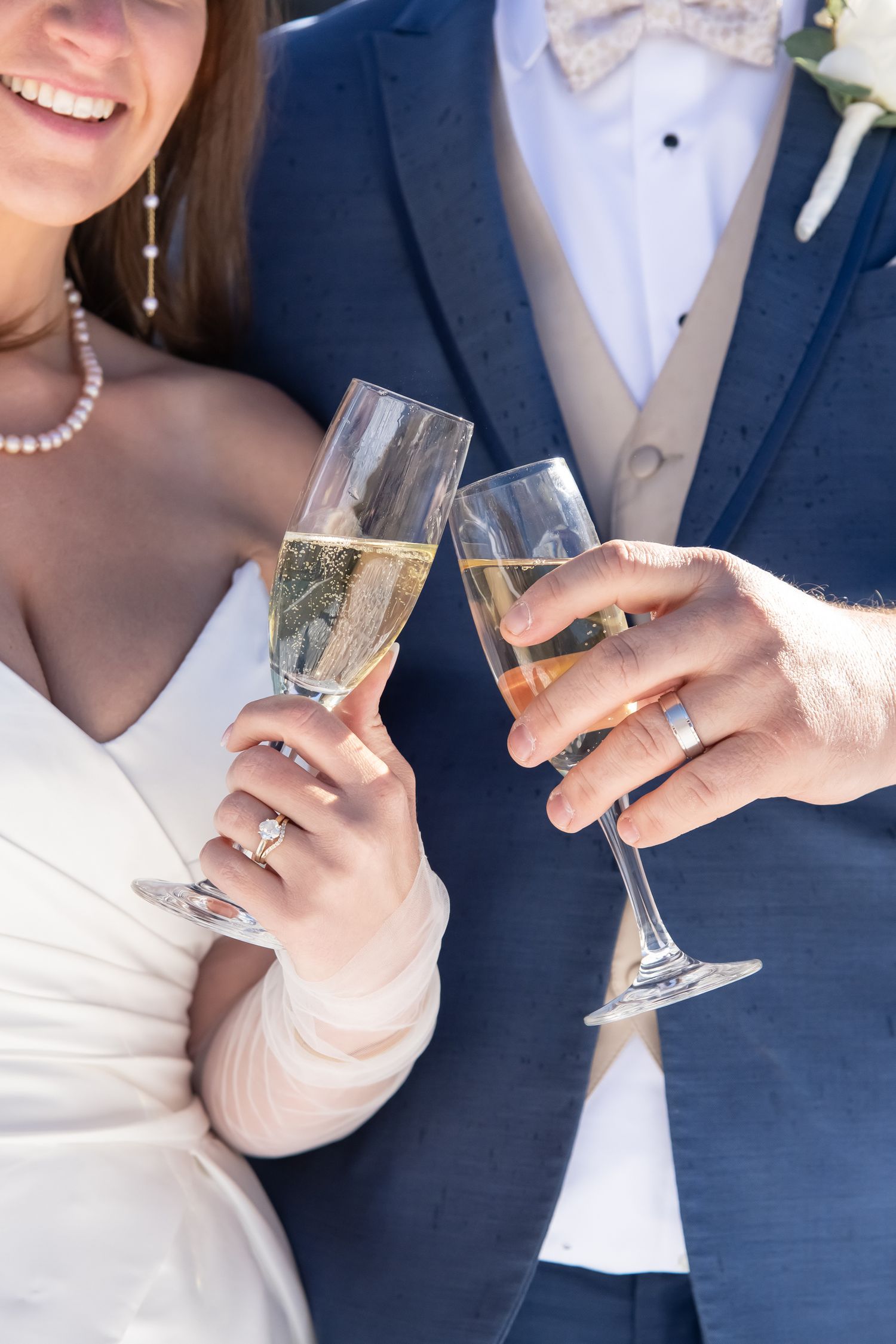Bride and groom cheers champagne glasses after their small wedding in Beaver Creek Colorado