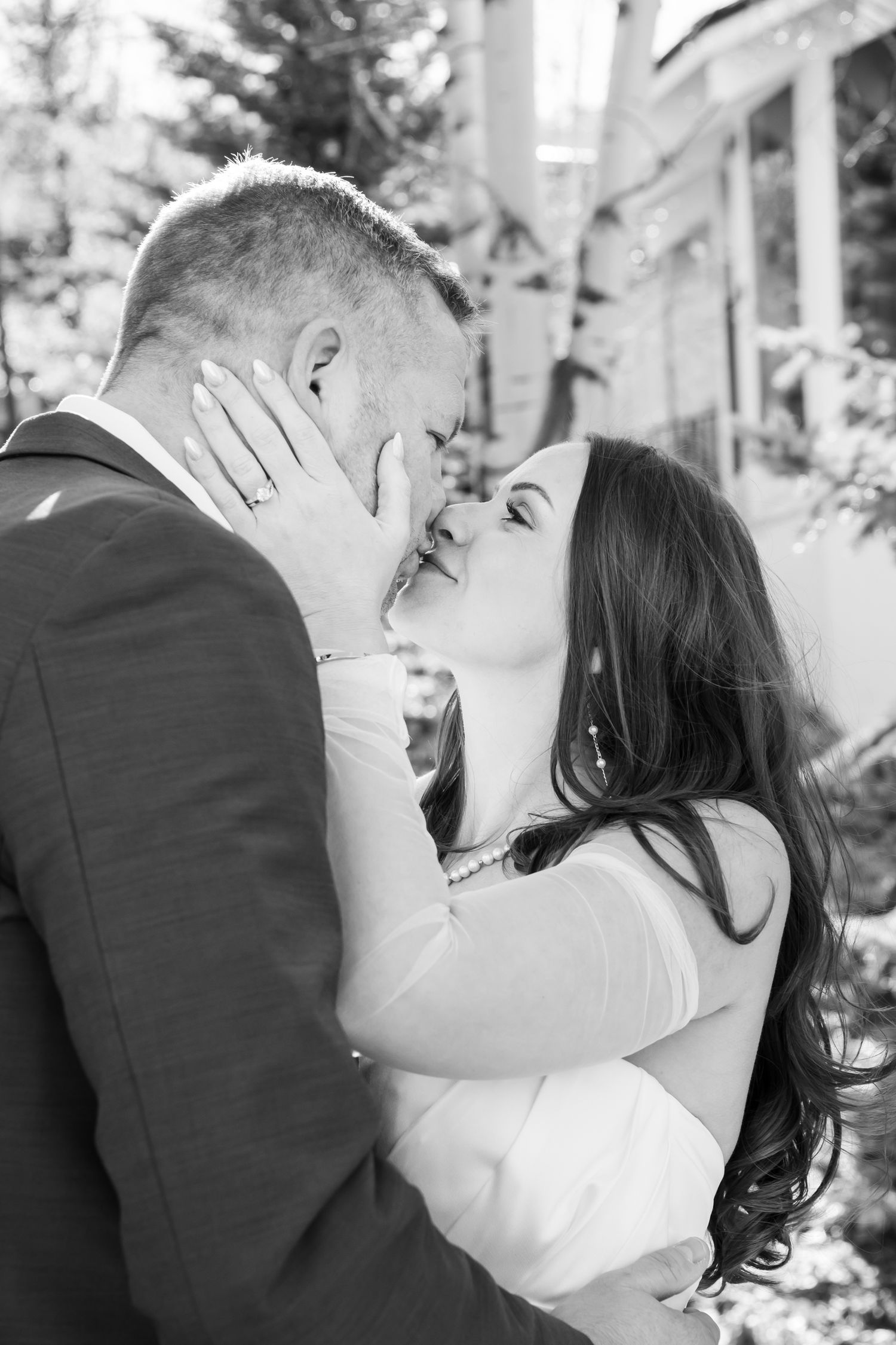 A romantic black and white photo sequence shows a couple sharing intimate kisses during their wedding celebration in Vail Colorado