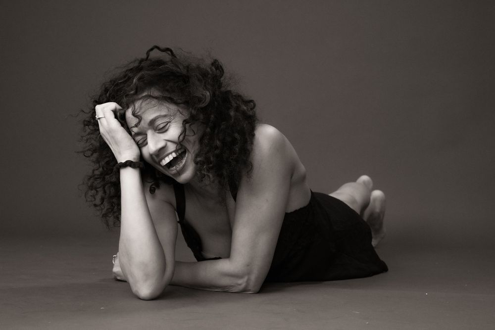 Artistic black and white portrait series showing graceful poses against a dark background.