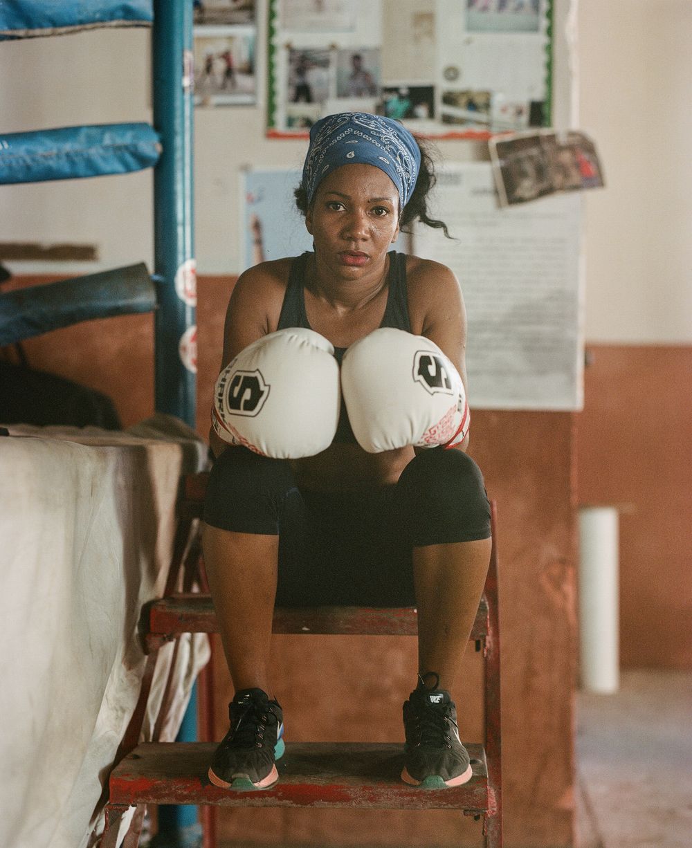 Boxing equipment and training gear in an indoor gym setting.