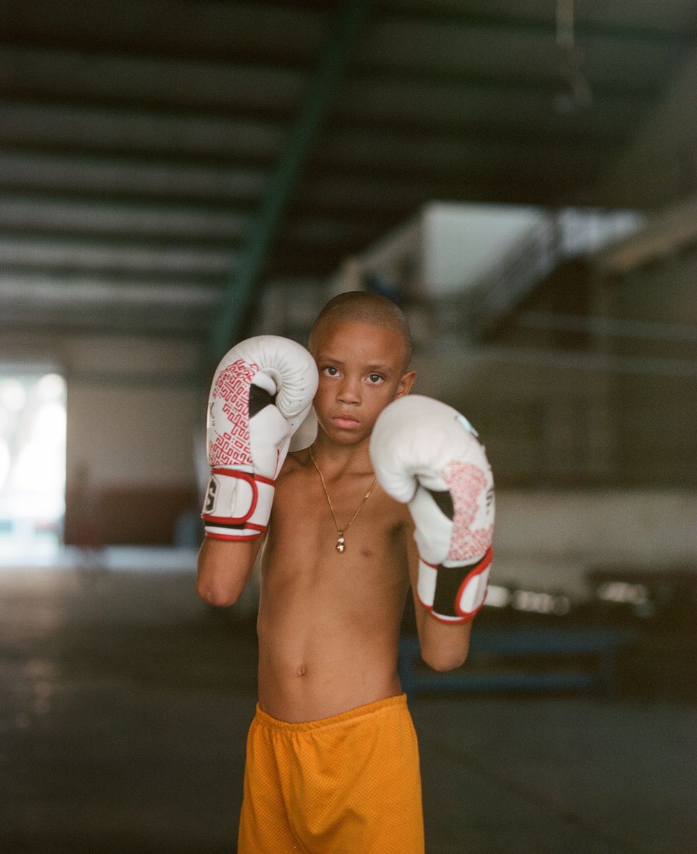 Boxing training session with white gloves and orange shorts.