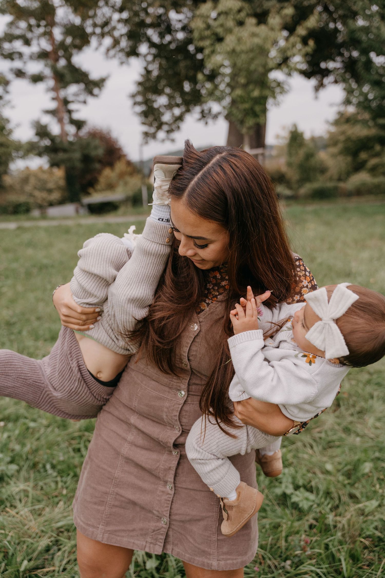 A series of candid outdoor photos showing tender moments between a parent and baby in matching beige outfits.
