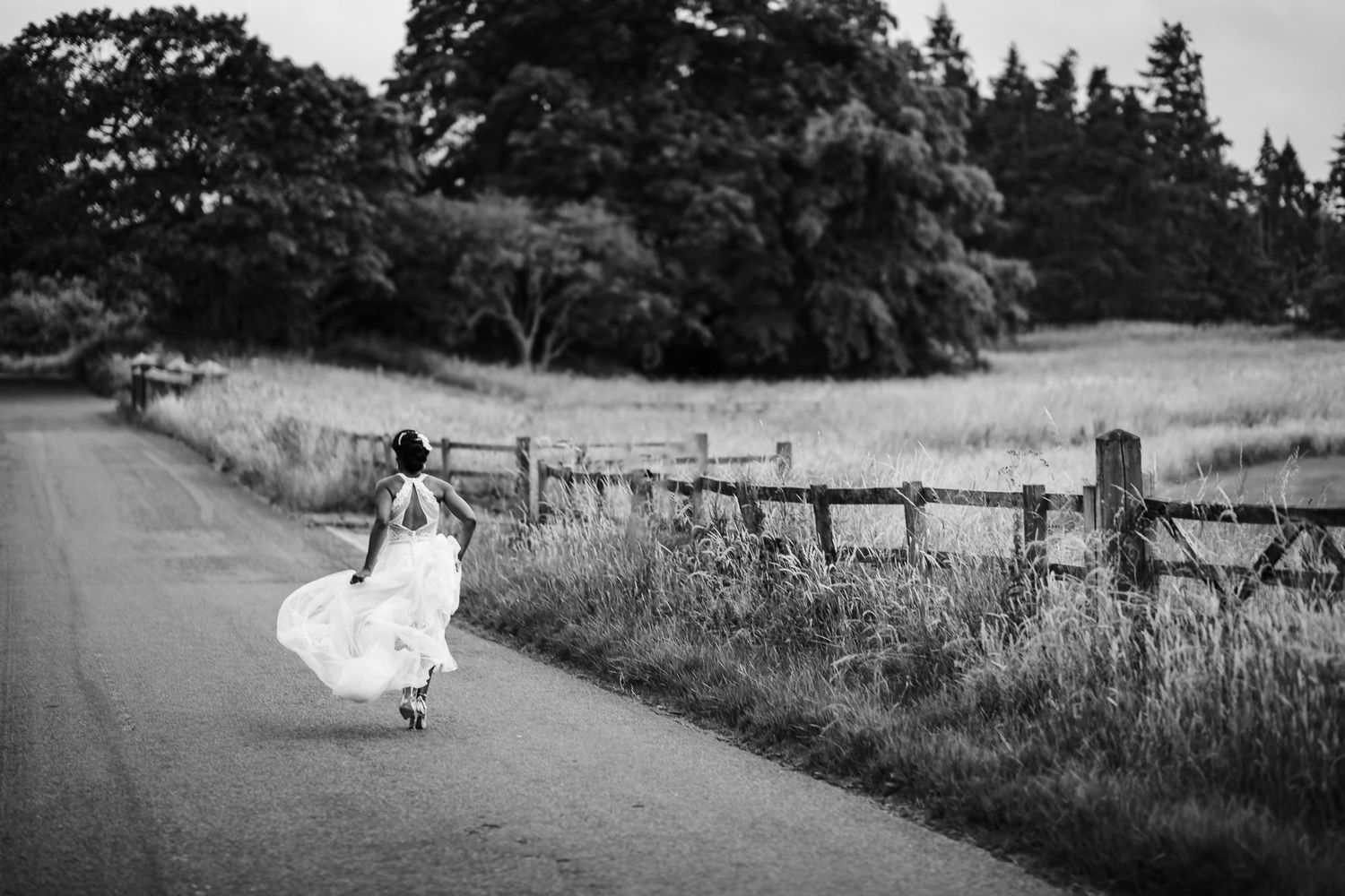 A black and white photo series shows a bride in a flowing white dress running through a rustic countryside path.