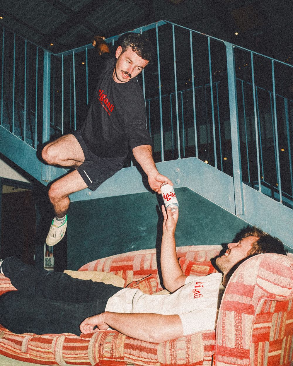 A sequence of skateboarding tricks being performed on a stair railing at night, shown in multiple action frames.