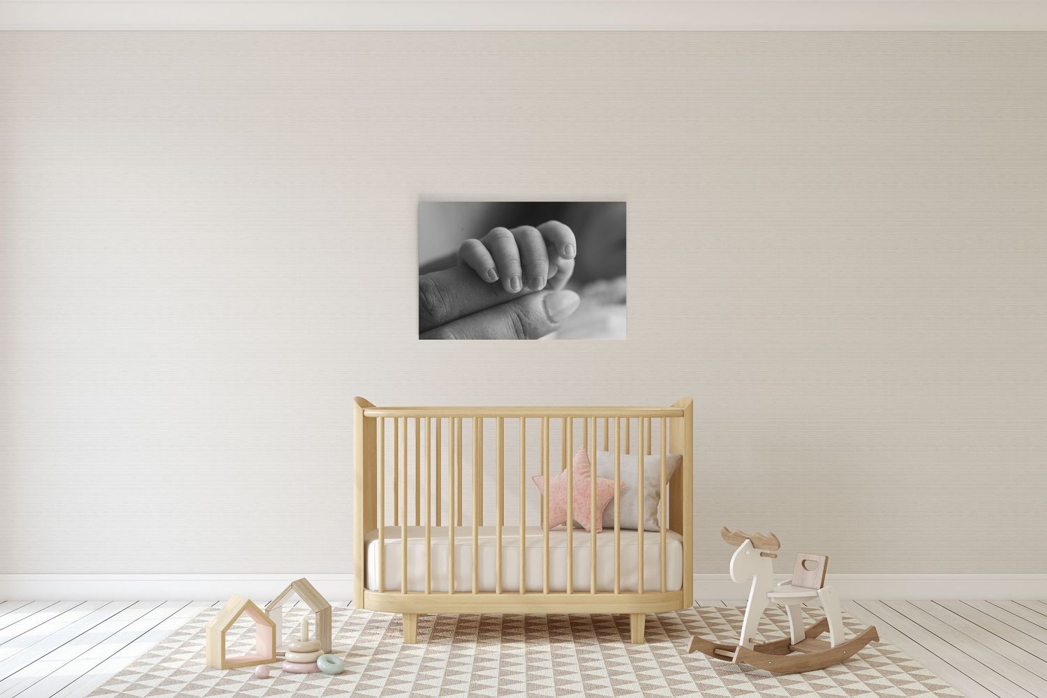 A modern wooden crib with simple lines sits against a white wall in a minimalist nursery setting.