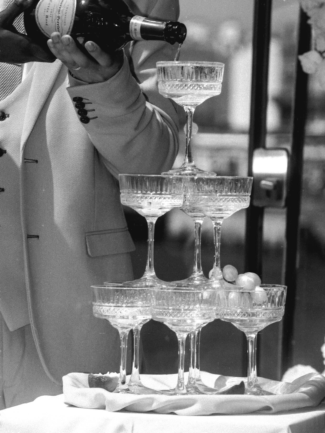 Elegant champagne tower setup with crystal glasses at a formal event.Pier One wedding, Plymouth