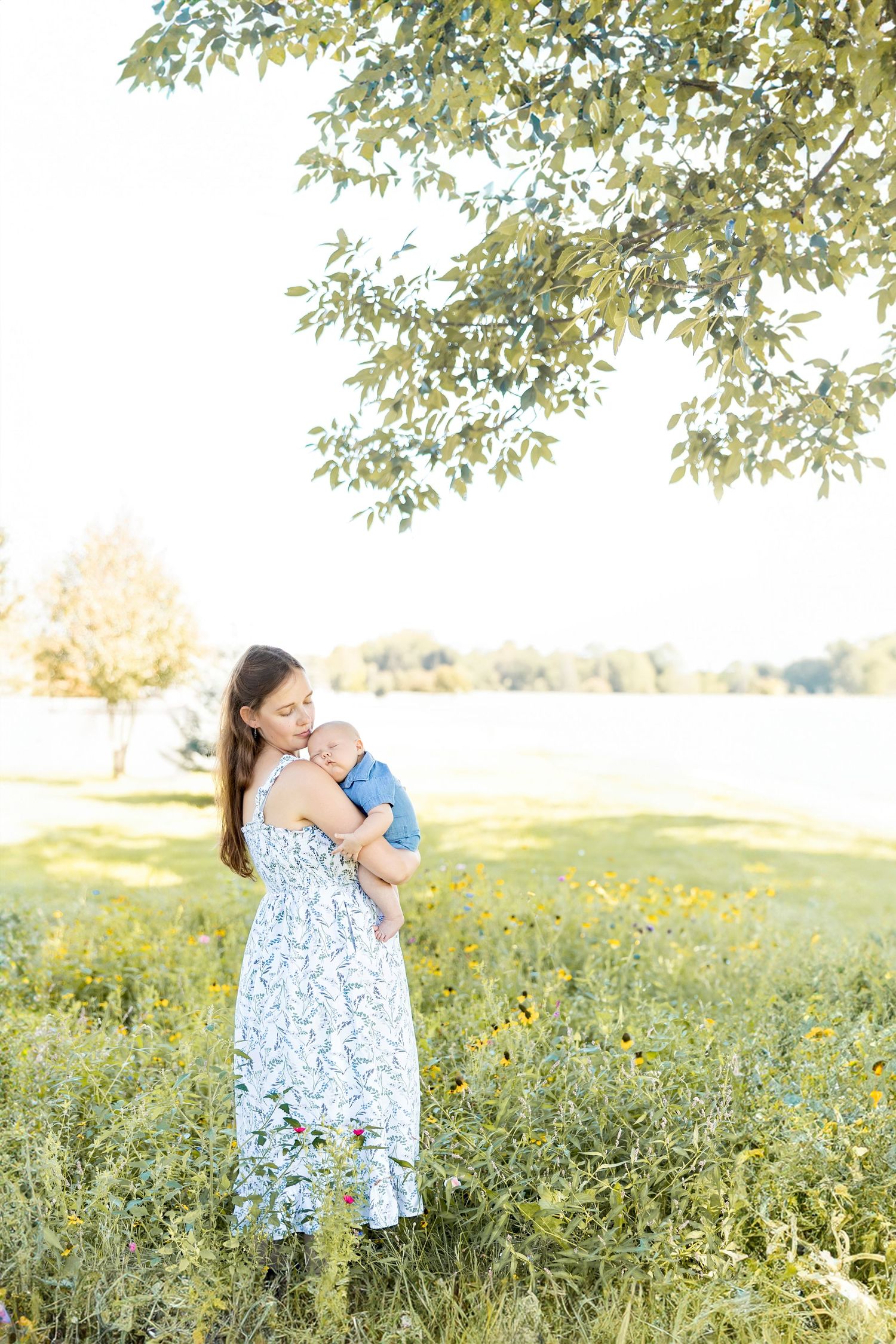 A floral dress sways in a sunny wildflower meadow during a summer photoshoot.