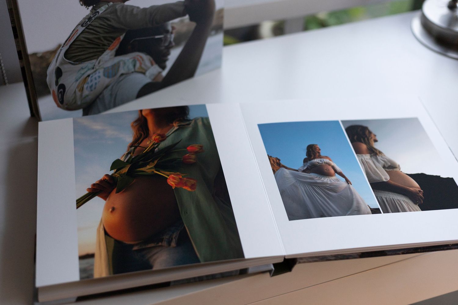A collection of printed photographs spread out on a light-colored surface showing various candid moments.