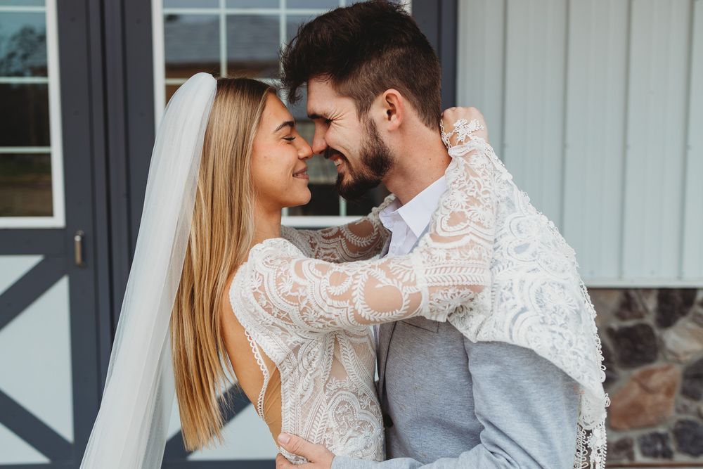 Romantic wedding portrait showing intimate moment between newlyweds.