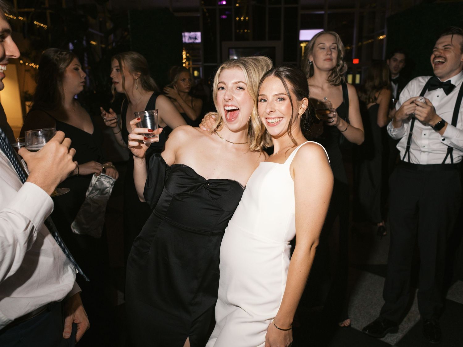 Wedding guests celebrate and dance together during a lively reception party.