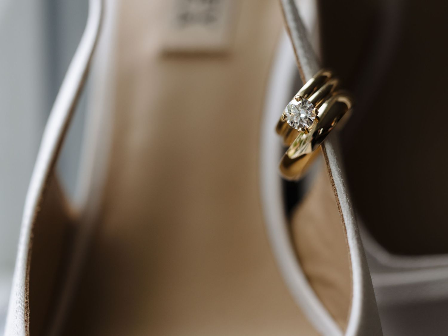 A close-up view of a silver metal door hinge with visible screws and mounting hardware.