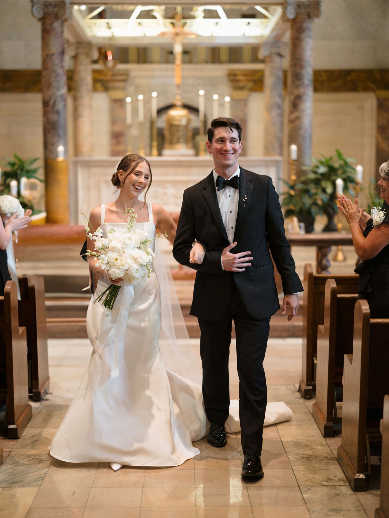 Candid sequence of joyful wedding couple walking down church aisle after ceremony.