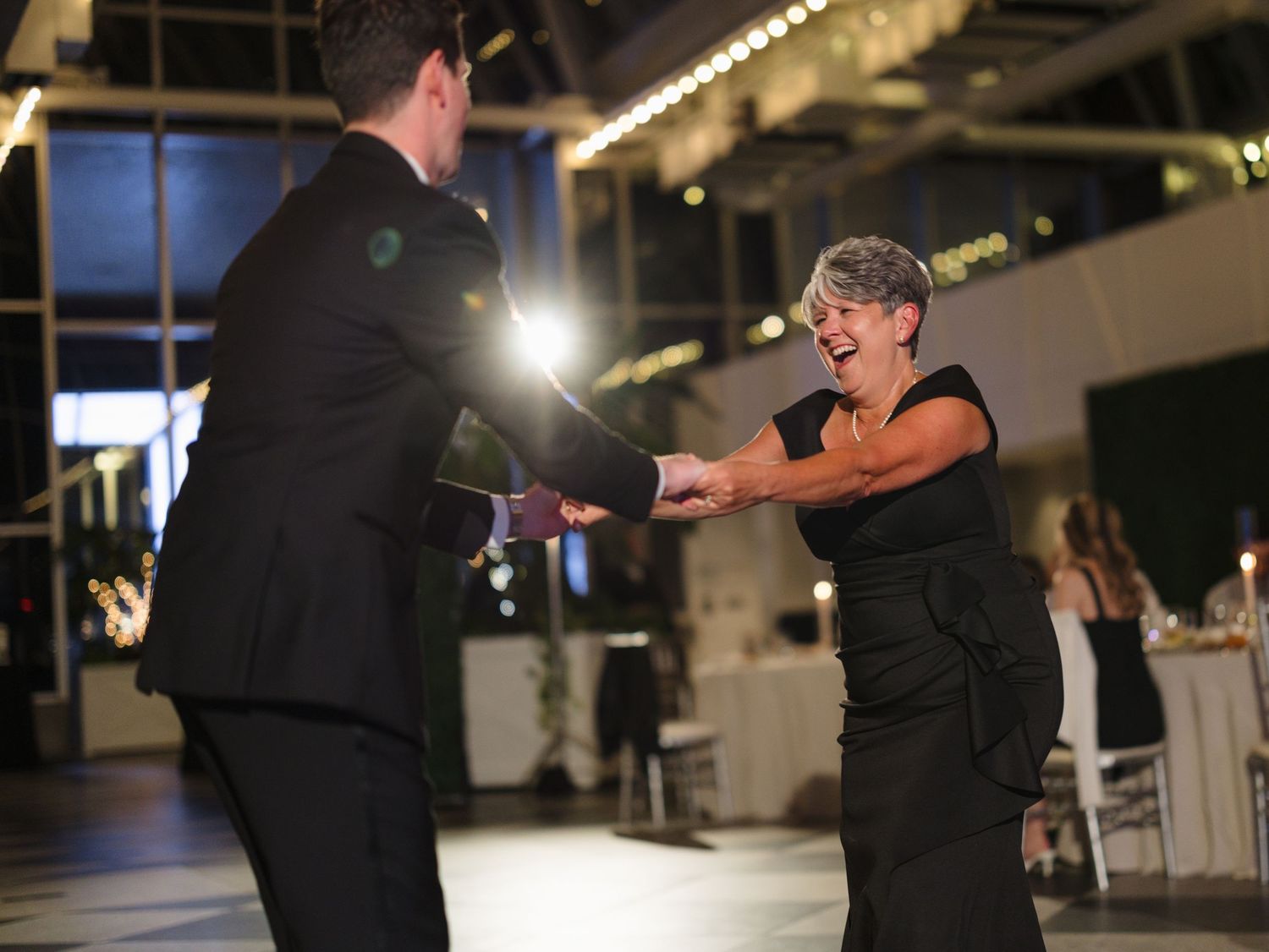 A sequence of dance moves being performed by two people in a dimly lit indoor space.