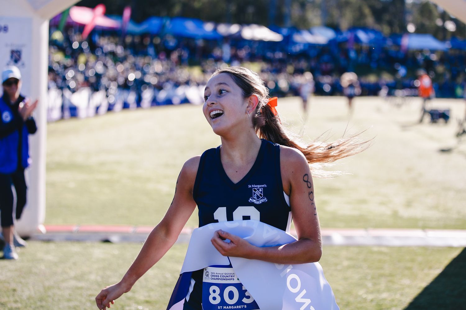 Cross country runner competing in outdoor race event.
