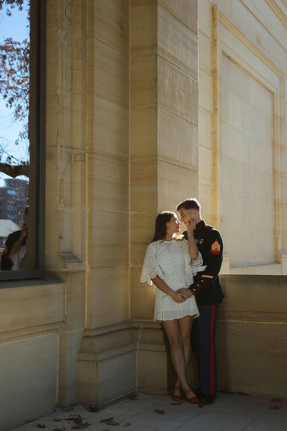 A couple shares an intimate moment as they take engagement photos outside of an art museum in Ann Arbor, Michigan.