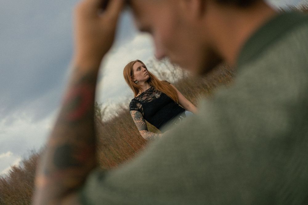 Romantic couple embracing in a dreamy outdoor setting with soft natural lighting and bokeh effect.