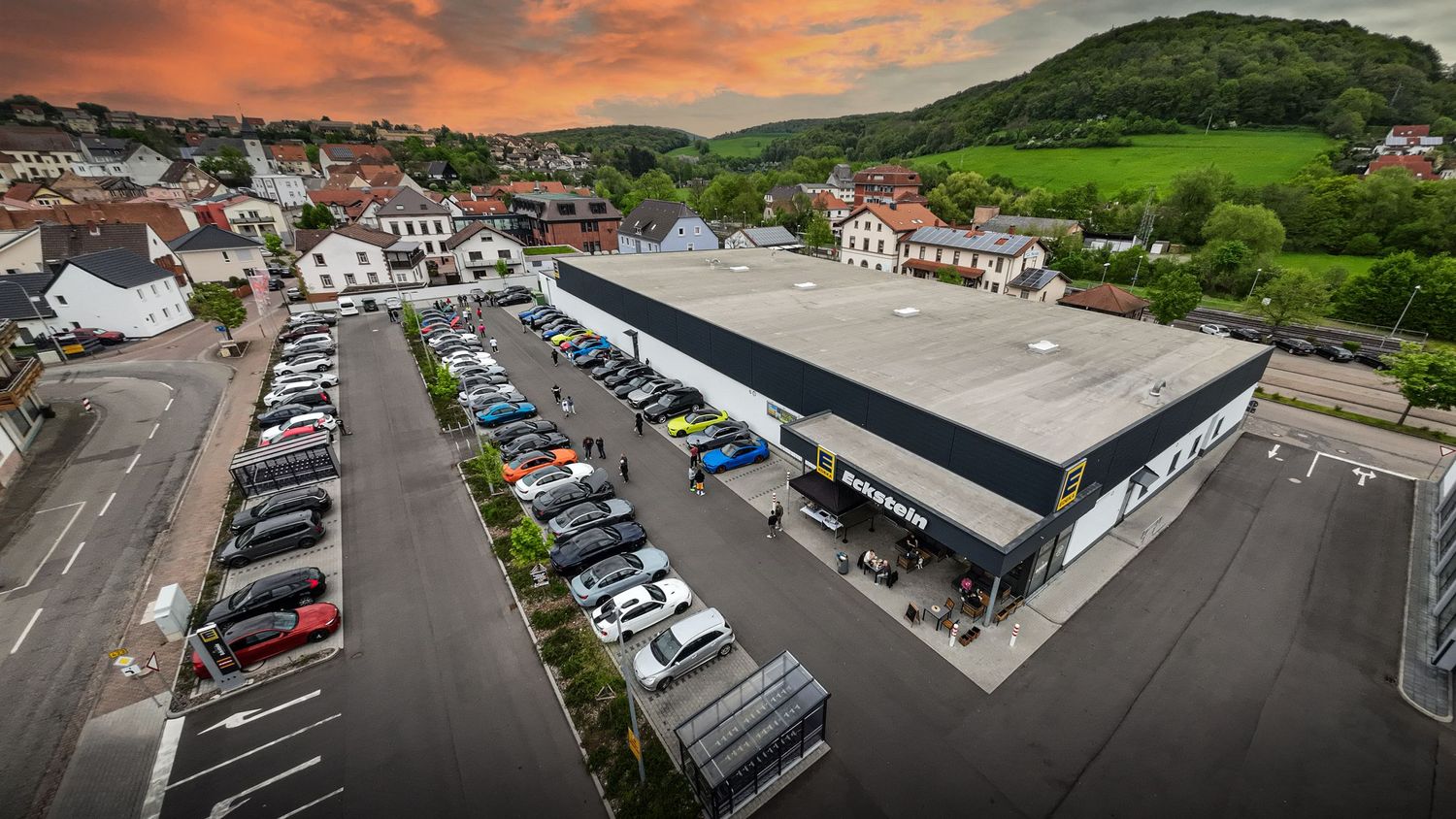 Drone photo of EDEKA Eckstein supermarket at sunset.