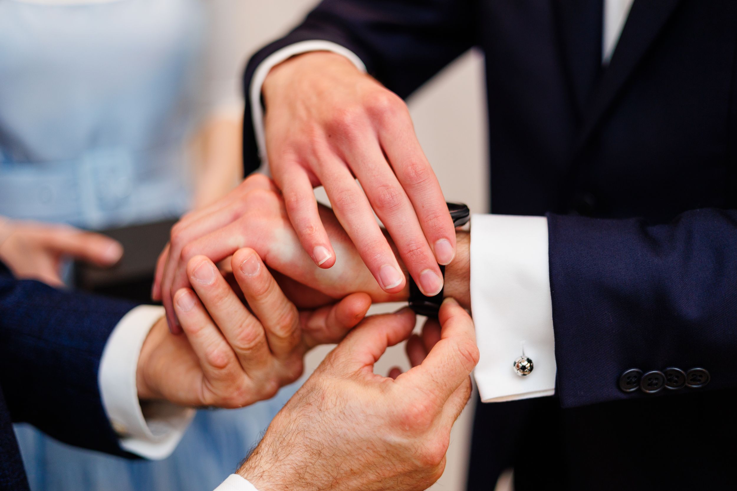 Close-up montage of hands exchanging wedding rings during a marriage ceremony.