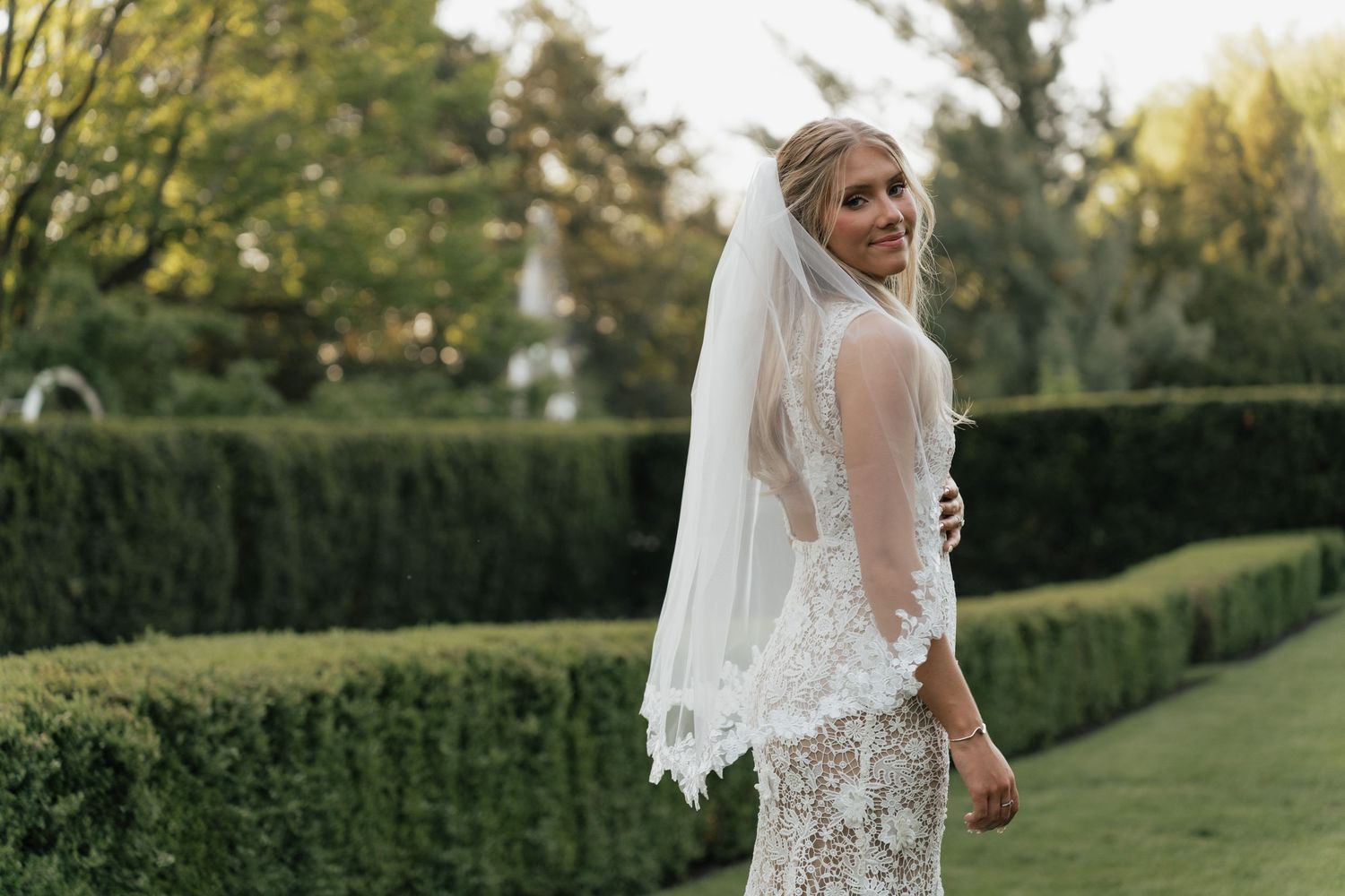 A vintage wedding scene with heart-shaped sunglasses, open-toed heels, and a delicate lace item on a spotted plate.