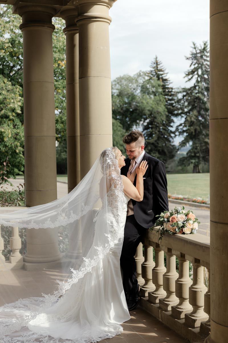 Romantic wedding photography featuring a bride and groom at the Government House in Edmonton.