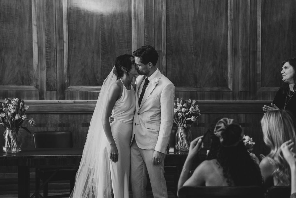 Black and white wedding photo capturing an intimate moment between newlyweds.