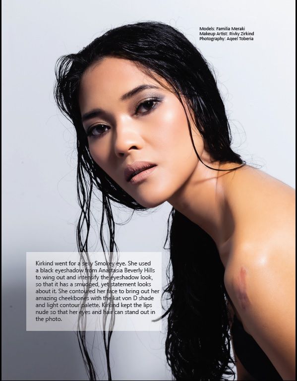 Fashion beauty editorial portrait with wet-look hair styling against white background.