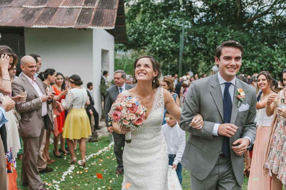 Newlyweds walking out of a Colombian church after wedding ceremony.