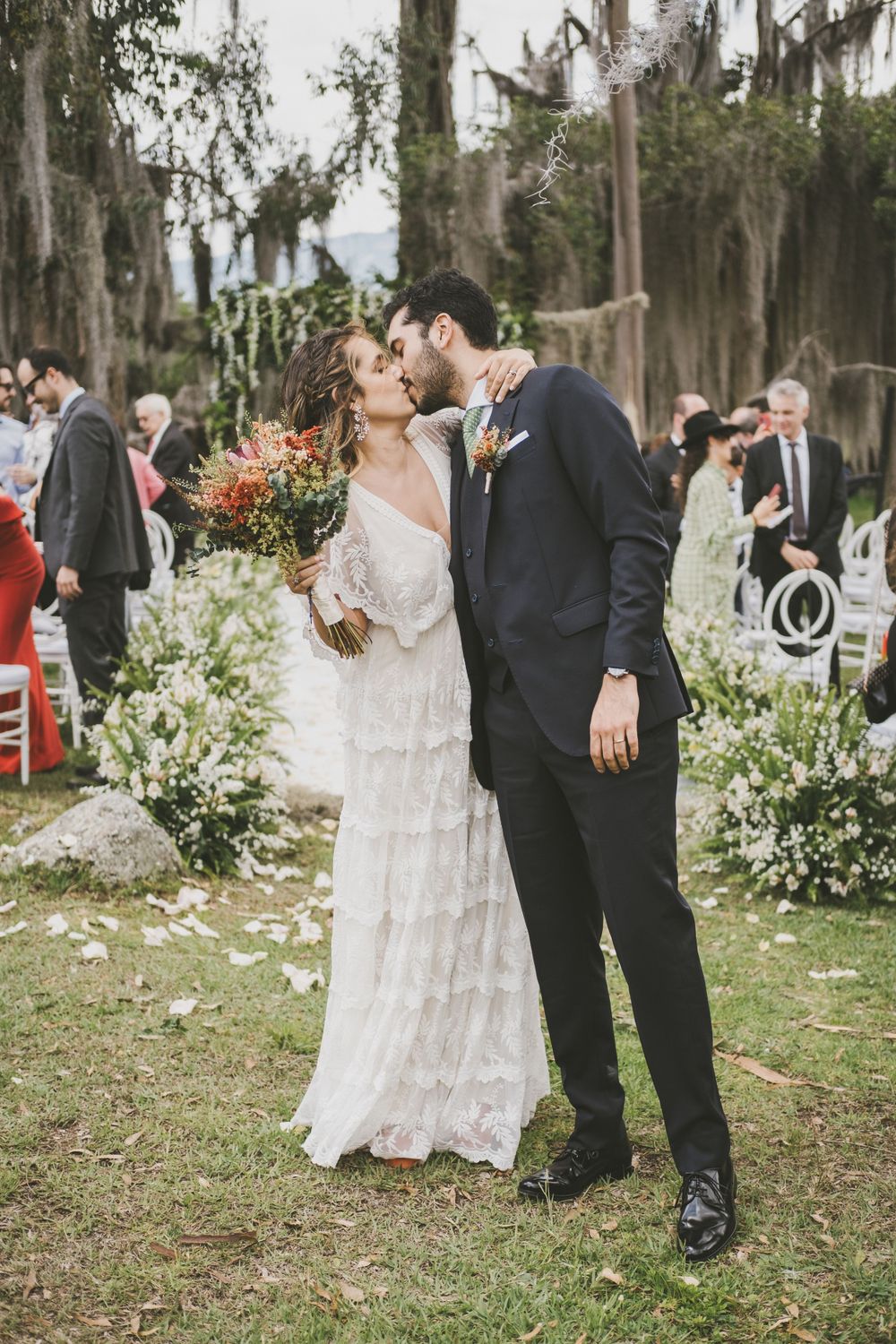 Newlyweds kissing after wedding ceremony in Colombia.