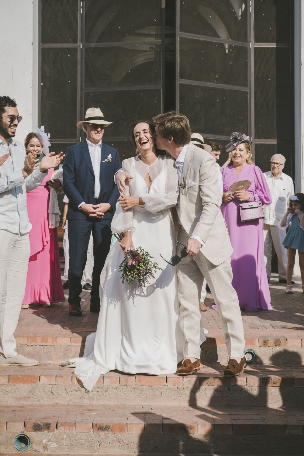 Newlyweds kissing after wedding ceremony in Colombia.