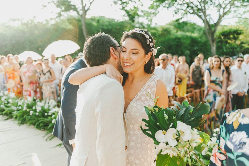 Groom kissing his bride during wedding ceremony.