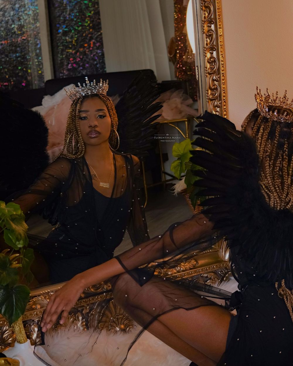Artistic portrait with crown and sparkly dress in mirror reflection.