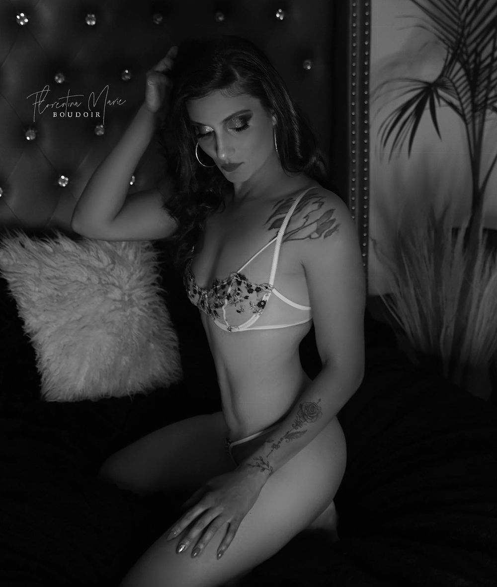 Black and white boudoir photography with decorative interior elements.