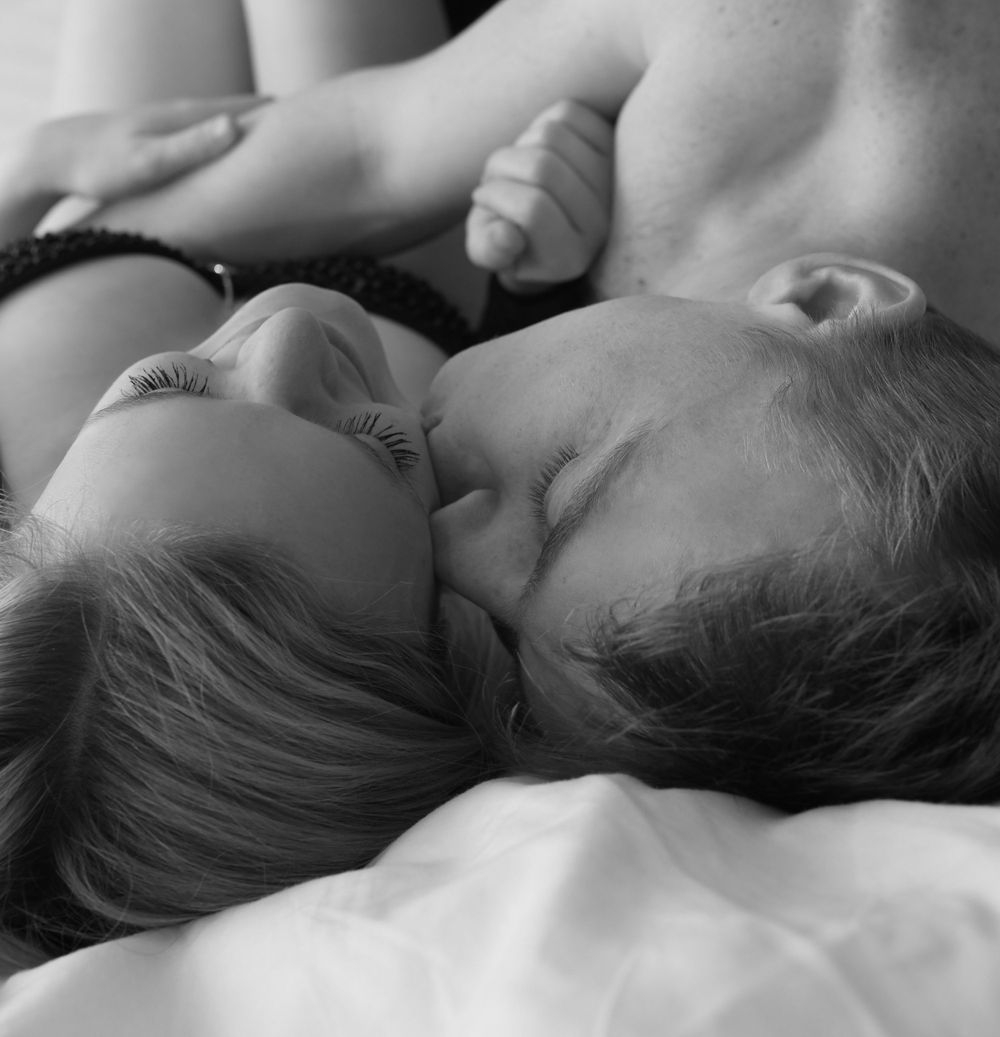 Black and white intimate portrait of a couple sharing a tender moment.
