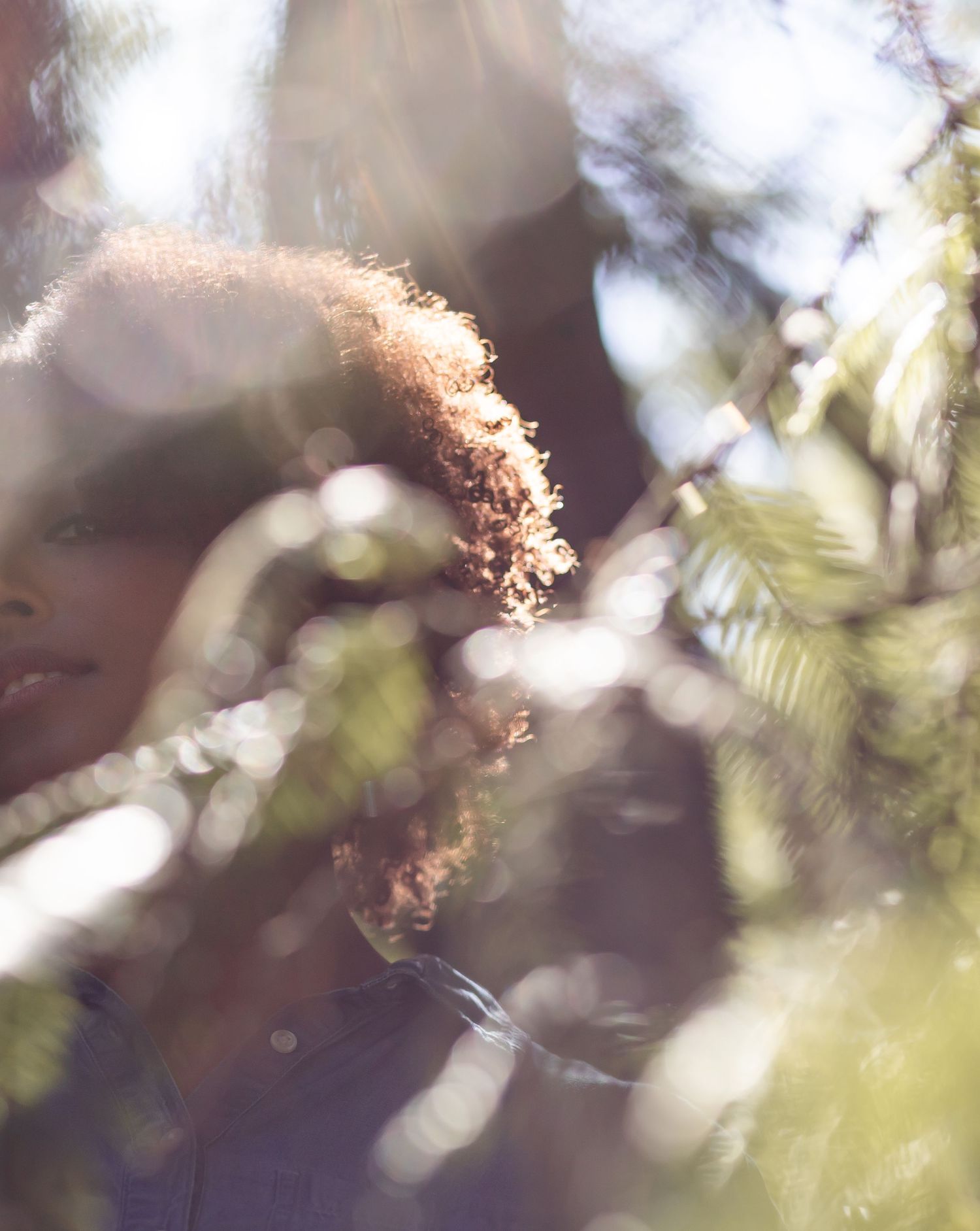 Girl staring through blurred Maui forest ferns
