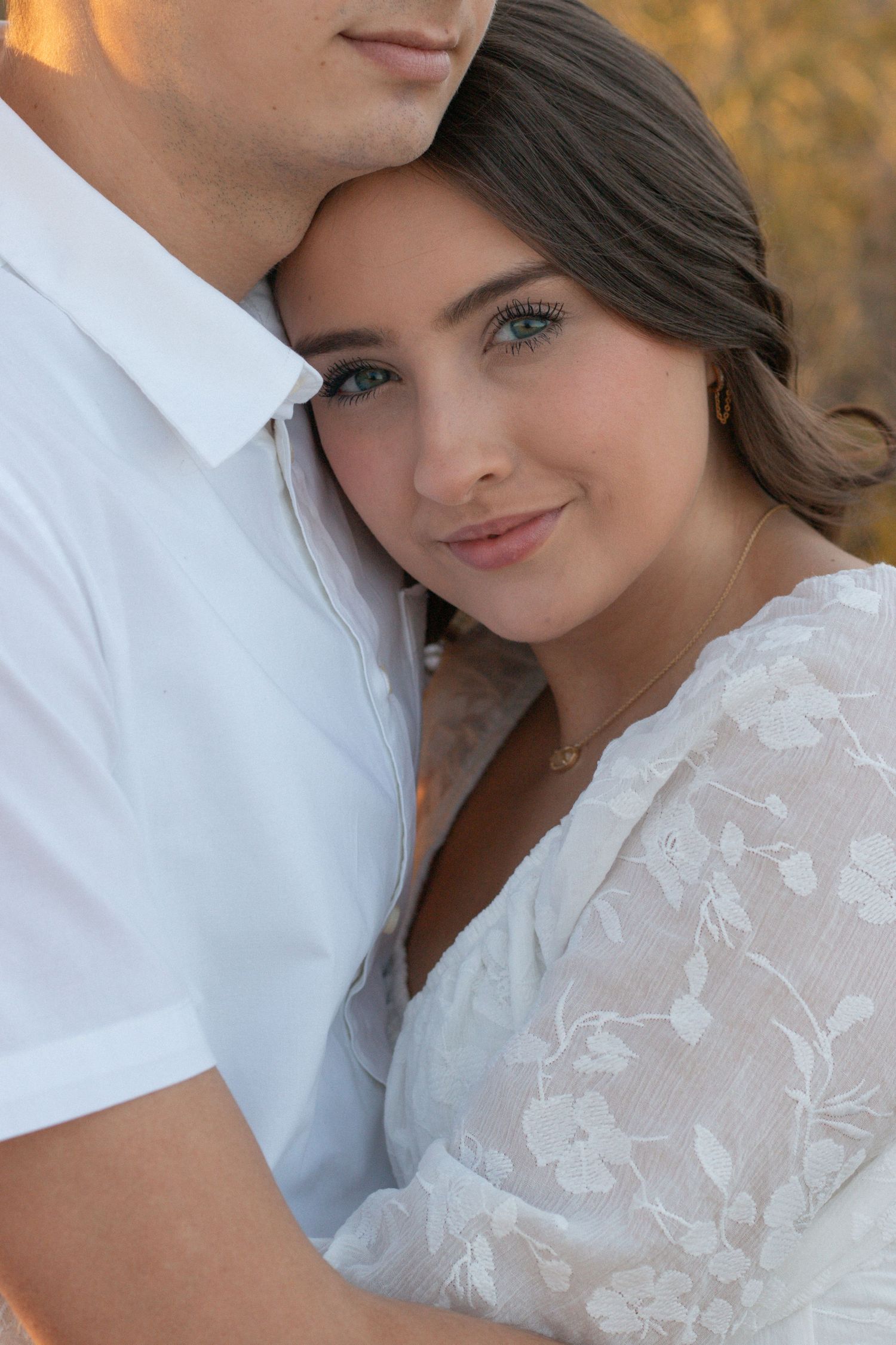 Couple photo session at sunset in the Greater Phoenix area, capturing a romantic moment with warm, glowing desert light.